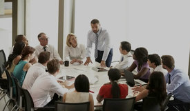 a group of corporate employees sitting around a conference table